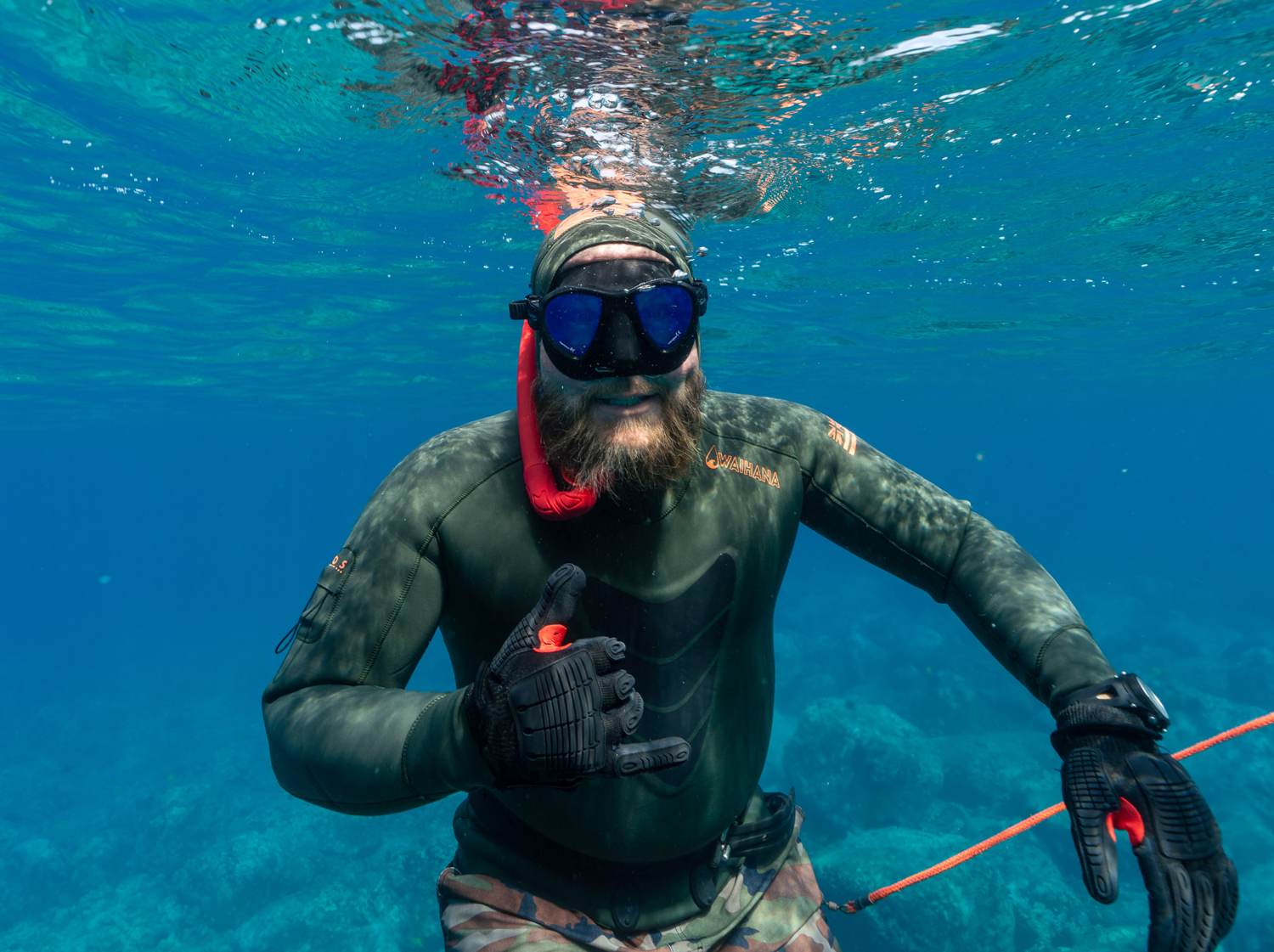 Freediver just below the surface in clear Kona water